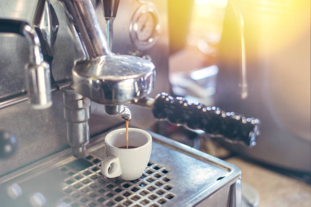 Proffessional brewing - coffee bar details. Espresso coffee pouring from espresso machine. - Фото, изображение