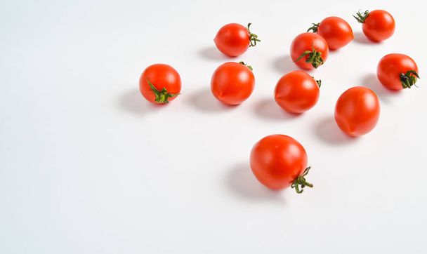 A lot of ripe mini cherry tomato on a white backgroun - Фото, изображение