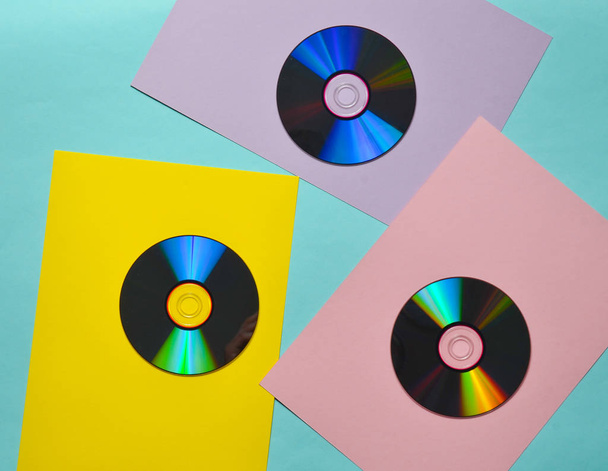 Computer CDs on a colored paper background. Retro Media. Top vie - Photo, Image