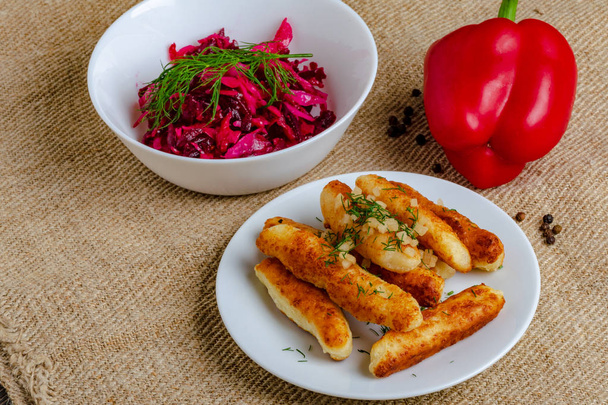 Breaded cheese and kefir sticks. Made from cheese, flour and kefir. Served with red salad. - Photo, Image