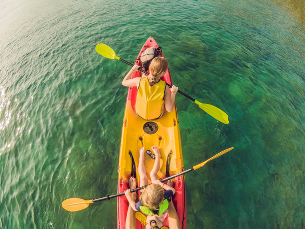 Mother and son kayaking at tropical ocean - Фото, изображение