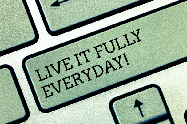 Writing note showing Live It Fully Everyday. Business photo showcasing Be optimistic enjoy life Happiness Successful Keyboard key Intention to create computer message pressing keypad idea. - Photo, Image