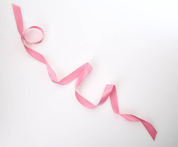 Curled pink ribbon on white background, Empty space for design - Photo, Image