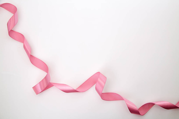 Curled pink ribbon on white background, Empty space for design - Фото, зображення