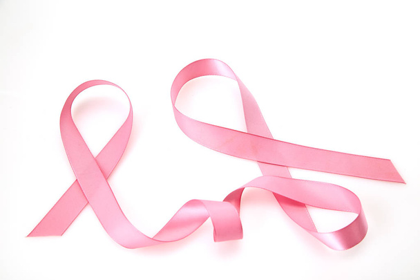 Curled pink ribbon on white background, Empty space for design - Photo, image