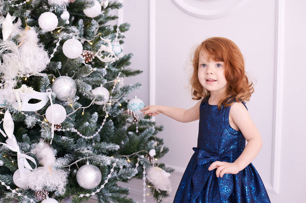 Little girl. Happy child. Blue dress. Christmas decorations. - Valokuva, kuva
