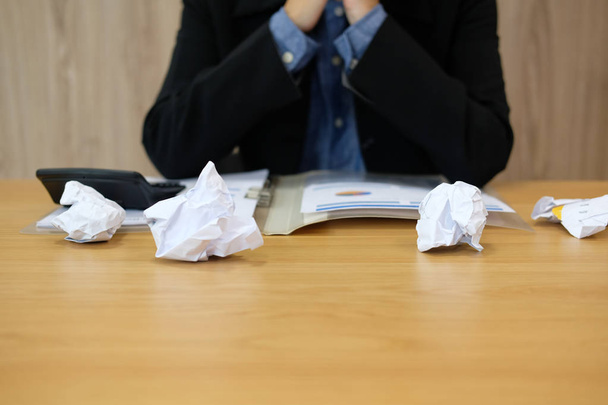 man feeling tired, frustrated & stressed from hard work with crumpled crushed paper on desk. exhausted businessman have headache at workplace. - Foto, immagini