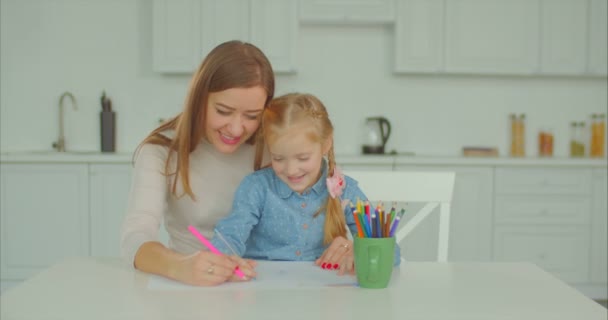 Cheerful mum and child busy with drawing at home - Кадри, відео