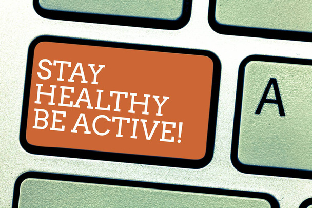 Writing note showing Stay Healthy Be Active. Business photo showcasing Take care of yourself make exercise workout Keyboard key Intention to create computer message pressing keypad idea. - Photo, Image