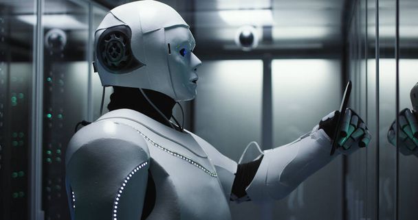 Humanoid robot checking servers in a data center - Photo, Image