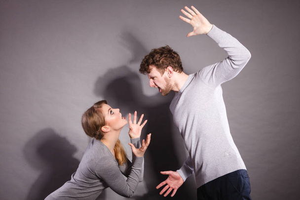 Negative emotions concept. People in fight. Husband and wife arguing and yelling on each other. Expressive and emotional couple having argument. - Fotoğraf, Görsel