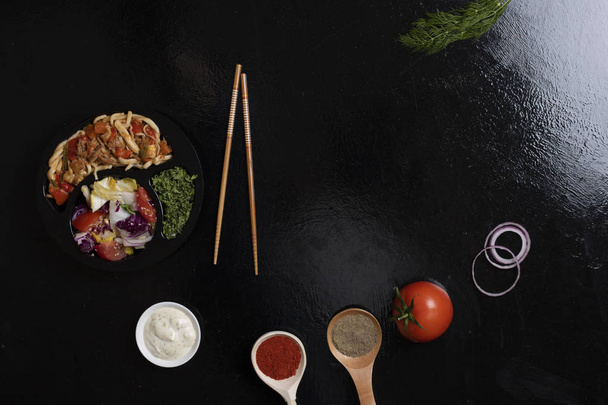 asian food into black box and spices round black stone background, top view - Fotoğraf, Görsel