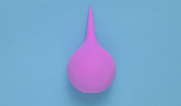 Enema on a pink background, medical concept, top view, minimalis - Photo, Image