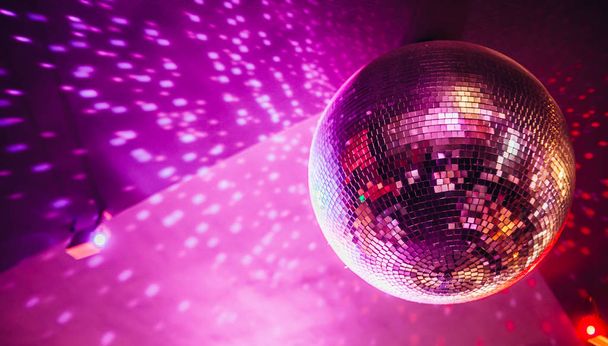 Disco ball sparkling with bright dots, night party background - 写真・画像