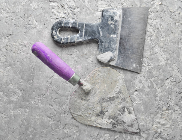 Herramientas de construcción sobre un fondo de hormigón gris. Espátula, paleta, top vie
 - Foto, Imagen