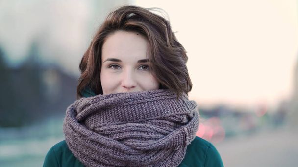 Beautiful cute young woman with a scarf on the street on background city. Urban style - Fotografie, Obrázek