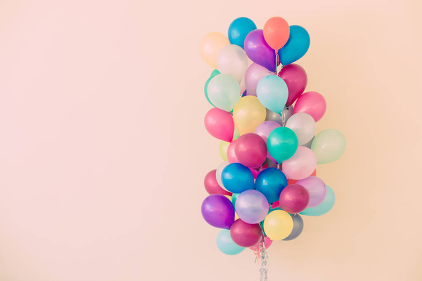 Group of colorful balloons on pastel color background. - Фото, изображение