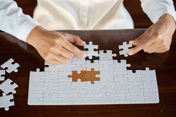 business woman hands connecting couple jigsaw puzzle piece against sunrise, Business solutions, target, success, goals and strategy concepts - Photo, Image