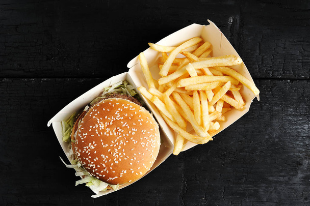 beef Burger with sesame bun and French fries fast food top view - Foto, Imagen