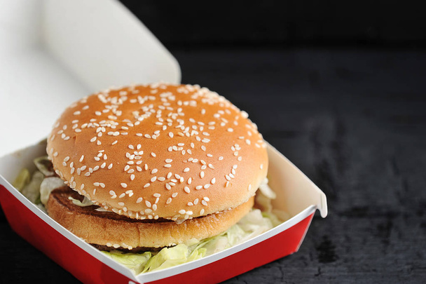 Burger with sesame bun close-up - 写真・画像