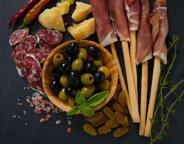 served antipasti olive background - Zdjęcie, obraz