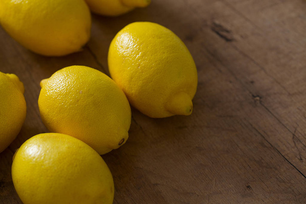 lemons on wooden surface - Foto, Imagen