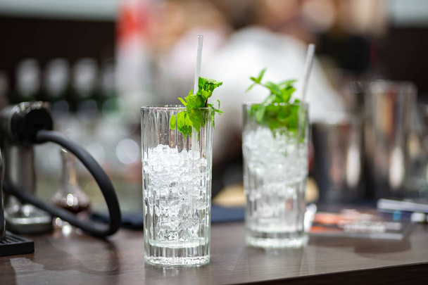 Two glasses with ice and mint on bar counter - Photo, image