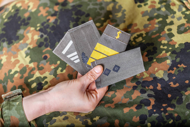 german shoulder ranks on a camouflage background - Photo, Image