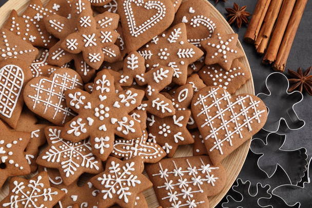 Homemade gingerbread cookies on a wooden plate. Top view. - Fotó, kép
