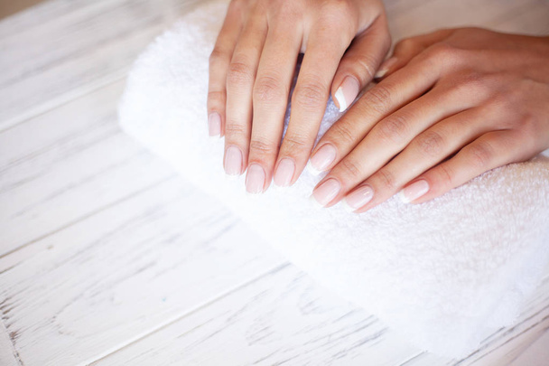 Woman Hand Care. Closeup Of Beautiful Female Hands Having Spa Manicure At Beauty Salon. Beautician Filing Clients Healthy Natural Nails With Nail File. Nail Treatment - Photo, Image