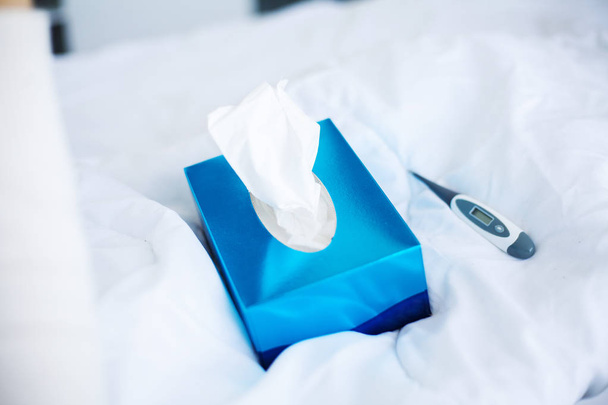 Facial Tissues Cube Box. Blue pack tissues on the bed - Foto, imagen