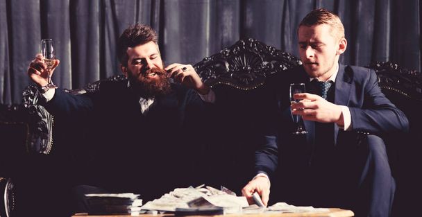 Men in suit, businessmen sit in dark luxury interior background. - Zdjęcie, obraz
