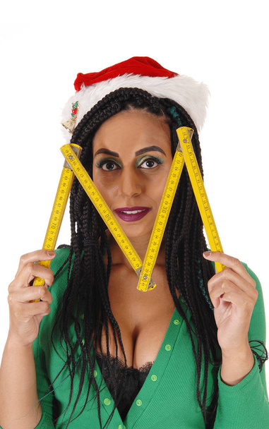 A young woman in a green body suit and Santa hat holding a woode - Photo, Image