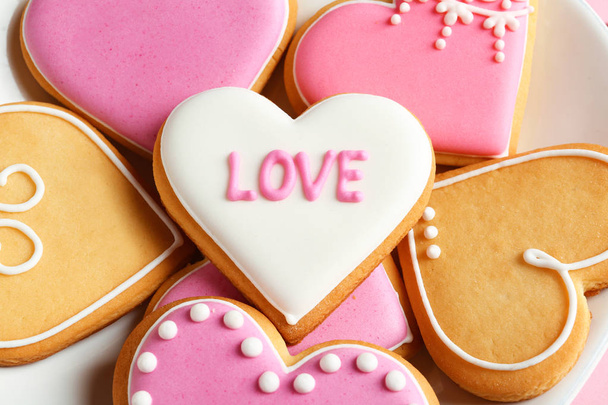 Decorated heart shaped cookies on plate, closeup. Valentine's day treat - Photo, Image