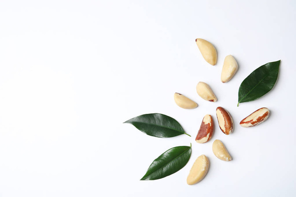 Composition with Brazil nuts and space for text on white background, top view - Photo, Image