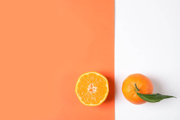 Flat lay composition with ripe tangerines on color background. Space for text - Фото, изображение