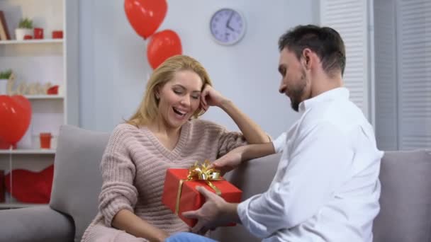 Boyfriend giving surprised happy lady gift for st Valentines day, happy couple - Filmagem, Vídeo