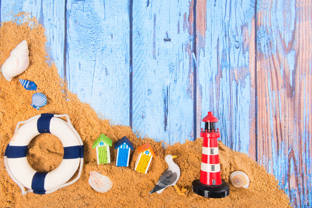 Beach poster on wooden background with cabines life buoy and lighthouse - Foto, Imagem