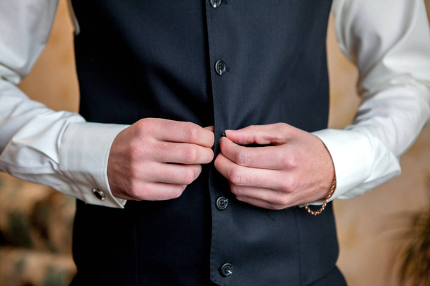 morning cooking, beautiful groom, dressed and preparing for a wedding, snap buttons . - Foto, immagini
