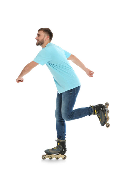 Young man with inline roller skates on white background - Фото, изображение