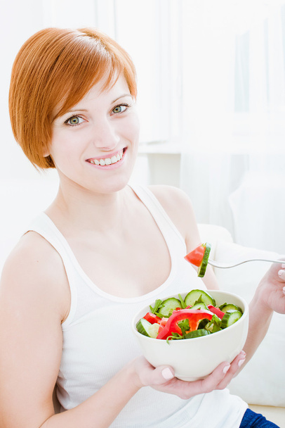 young happy woman eating salad - Photo, Image