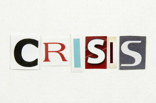 Слово кризис вырезали из газеты на белой бумаге
 - Фото, изображение