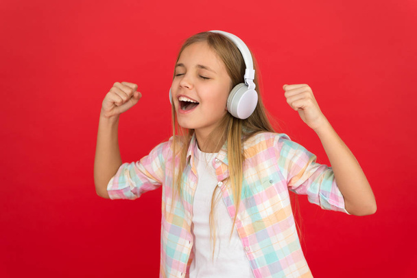 Little girl listen song headphones. Online radio station channel. Girl child listen music modern headphones. Get music account subscription. Enjoy music concept. Music always with me. Leisure concept - Zdjęcie, obraz