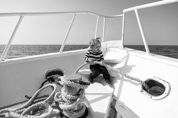 Travelling concept. Little child enjoy travelling on ship. Baby boy travelling by sea. Travelling on summer vacation. Between the sea and the sky - Zdjęcie, obraz