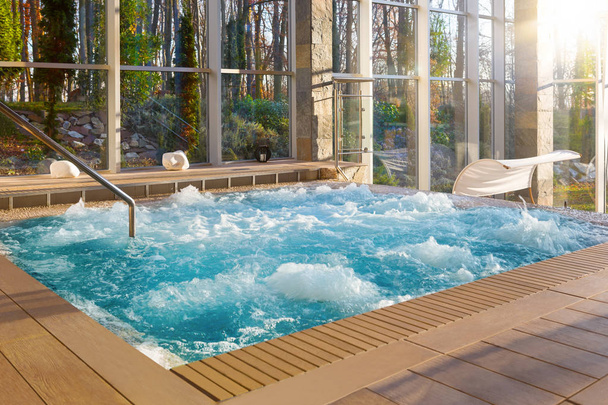 Luxurious hot tub spa in boutique hotel with big glass windows with nature view. - Photo, Image