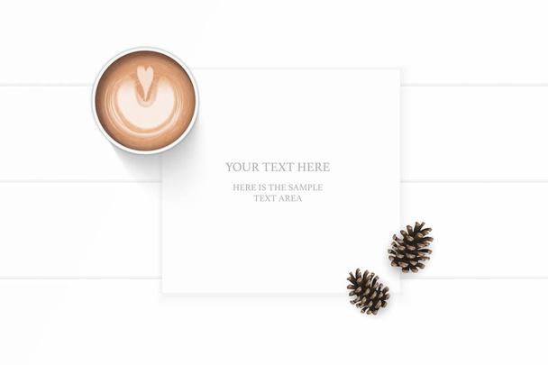 Плоский вид сверху элегантный белый композиционный бумажный коричневый сосновый конус и кофе на деревянном фоне
. - Вектор,изображение