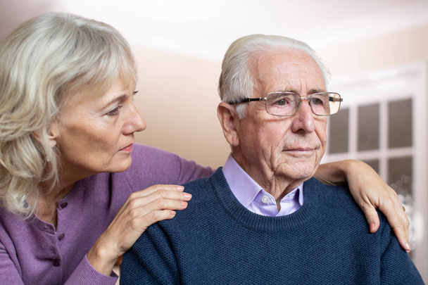 Confused Senior Man Suffering With Depression And Dementia Being Comforted By Wife - Фото, зображення