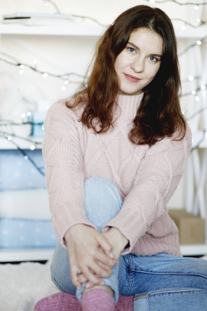 Closeup portrait of beauty brunette woman wearing blue jeans and winter sweater, blurred background - Photo, Image