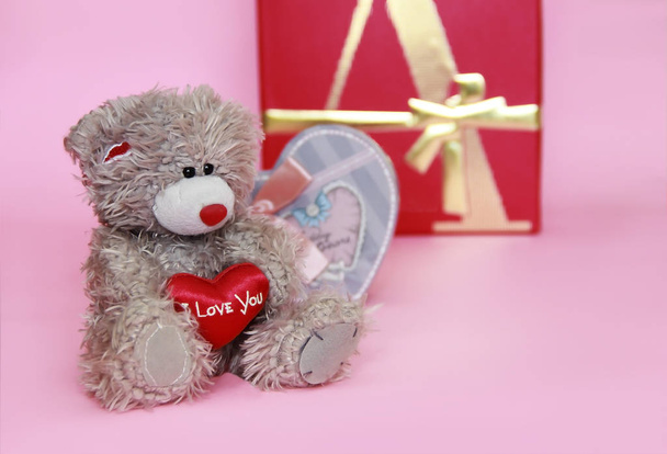 decorative gray teddy bear on pink background for the holiday Valentine's Day - Photo, Image