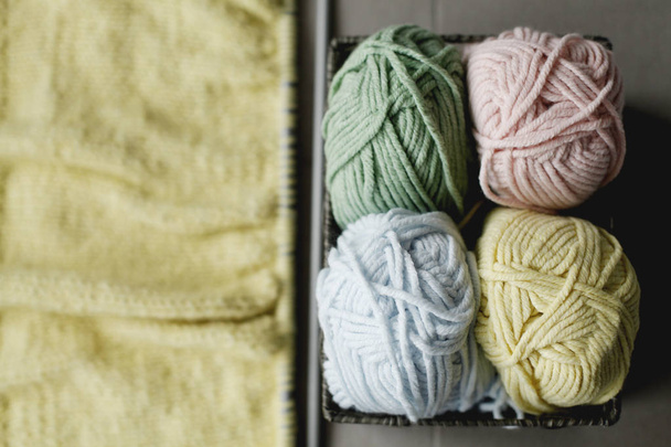 Strings for yarn with needles, closeup on grey sofa - Foto, Bild